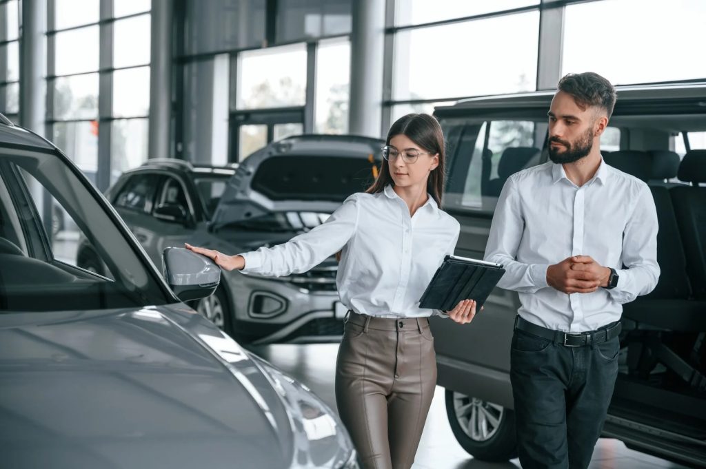 GMC dealership representative discussing new car financing options with a customer in Madras OR