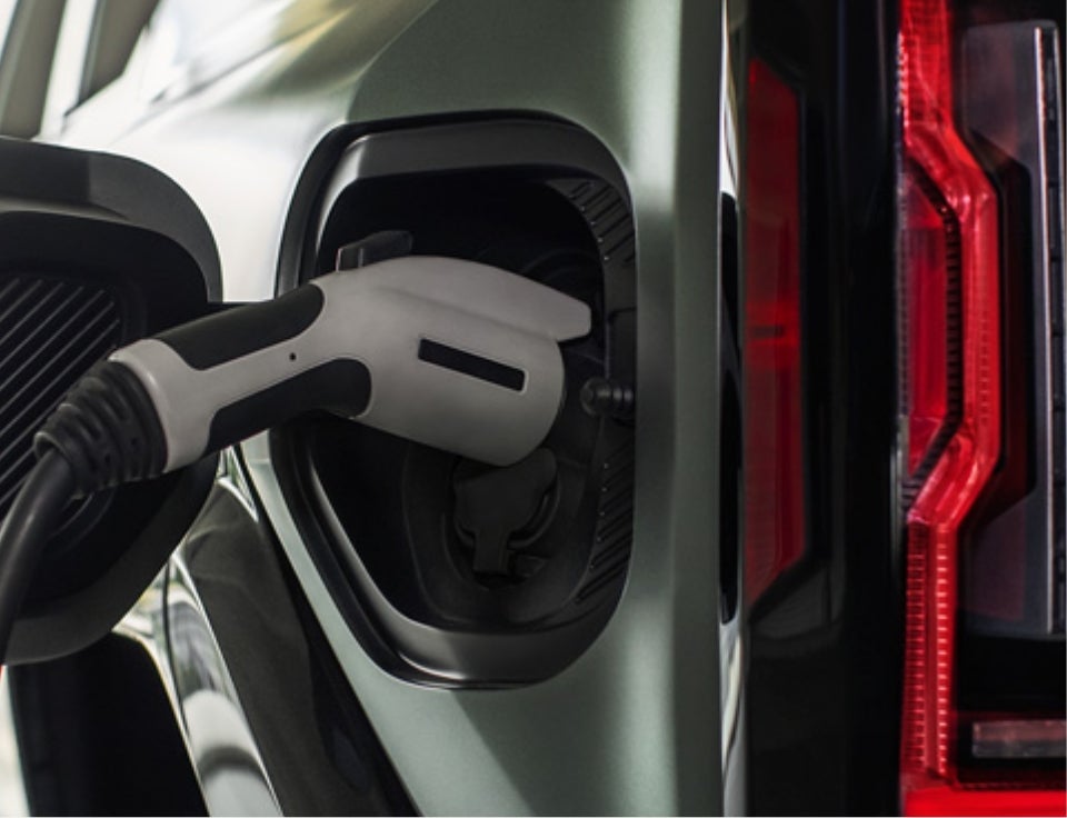 Close up of charging port with charger plugged in on a GMC Hummer EV SUV - GMC of Madras in MADRAS OR